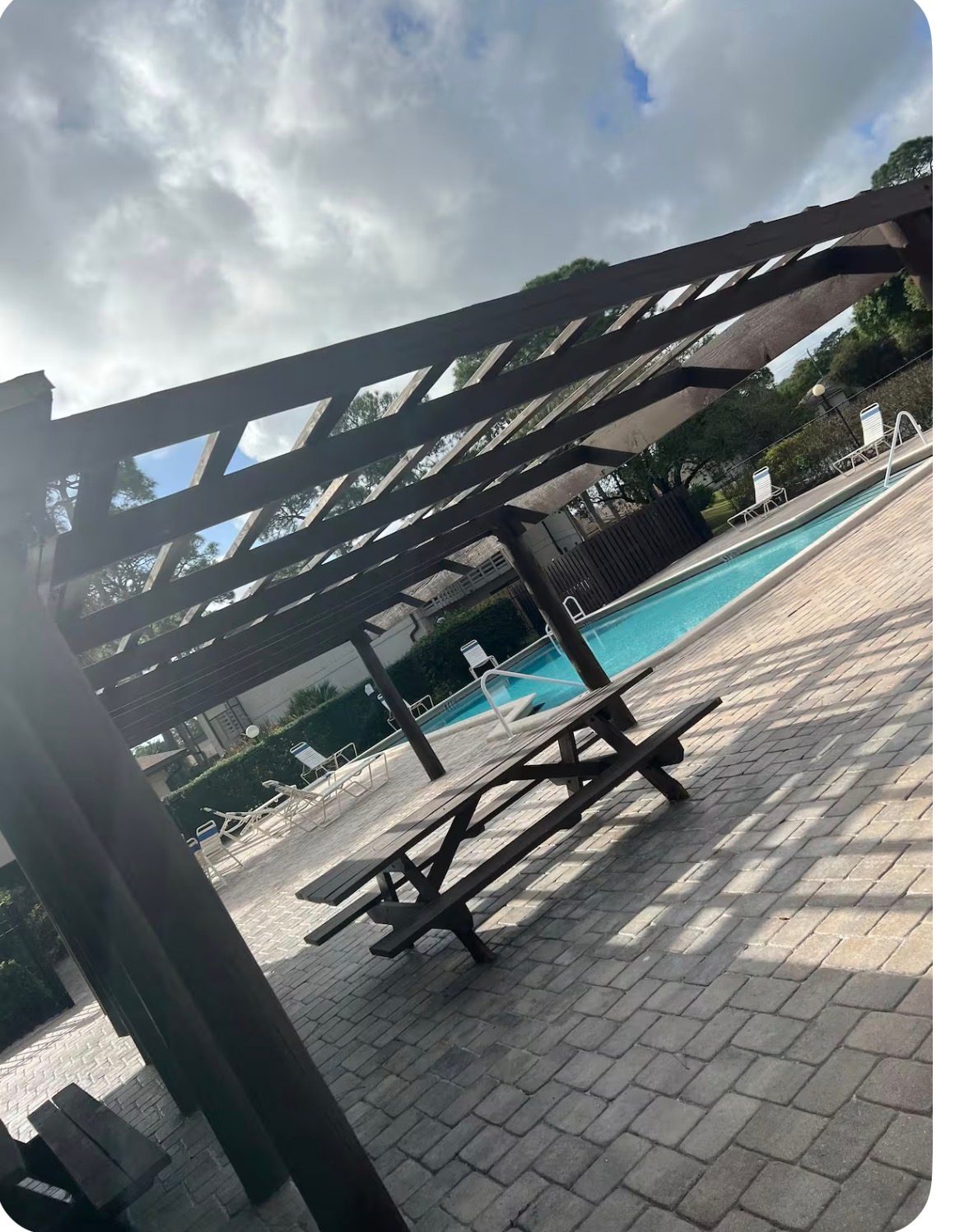 Pool: Shaded seating by the community pool - FL "Cozy Coastal Retreat  in ft pierce"